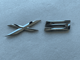 BMW GENUINE BMW - E53 E70 Rear Trunk Emblem Adhered 51148402675 — thumbnail 1